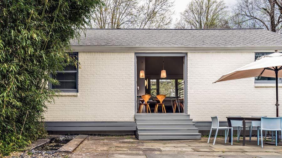 Dining Room Opens Onto Outdoor Patio with Fountain