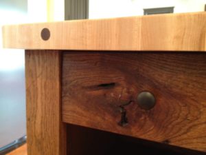 Kitchen island with wooden peg constructions & reclaimed wood character