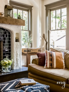 reclaimed wood mantle with plaster fireplace and cobalt blue subway tile.