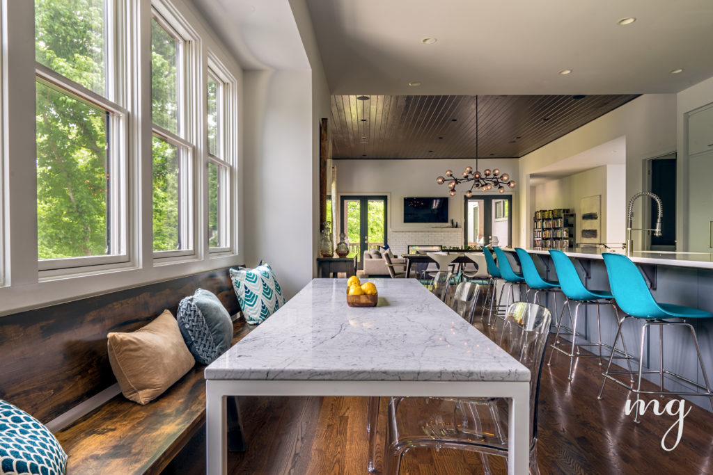 Bespoke rustic walnut bench balanced by modern clear lucite chairs