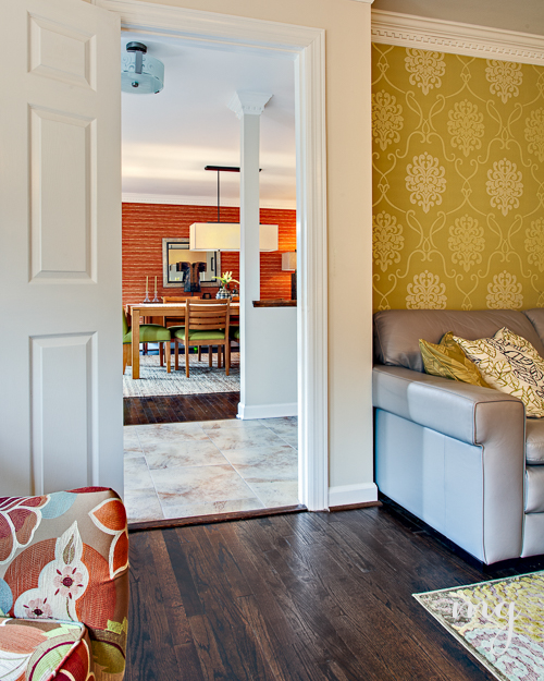 Bright pops of warm colors by using bold yellow damask and deep orange faux grasscloth wallpaper