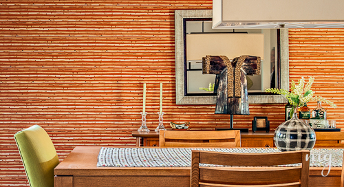 View of Dining Room with Orange Faux Grasscloth and Natural Grass Rug