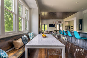 Bespoke rustic walnut bench balanced by modern clear lucite chairs