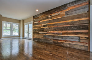 reclaimed wood feature wall behind entertainment center